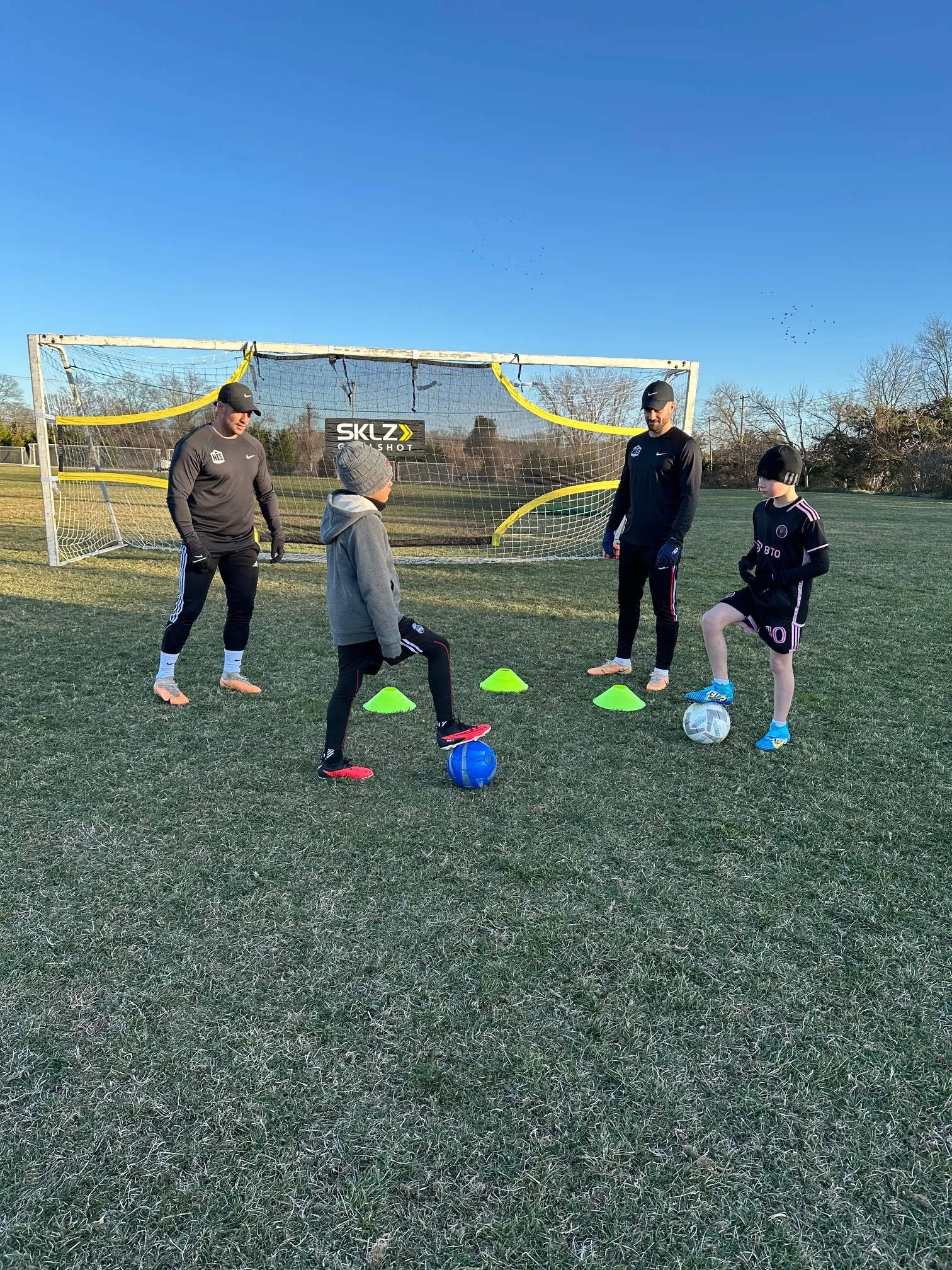 NLS trainers Mancuso and Johnson with soccer trainees.