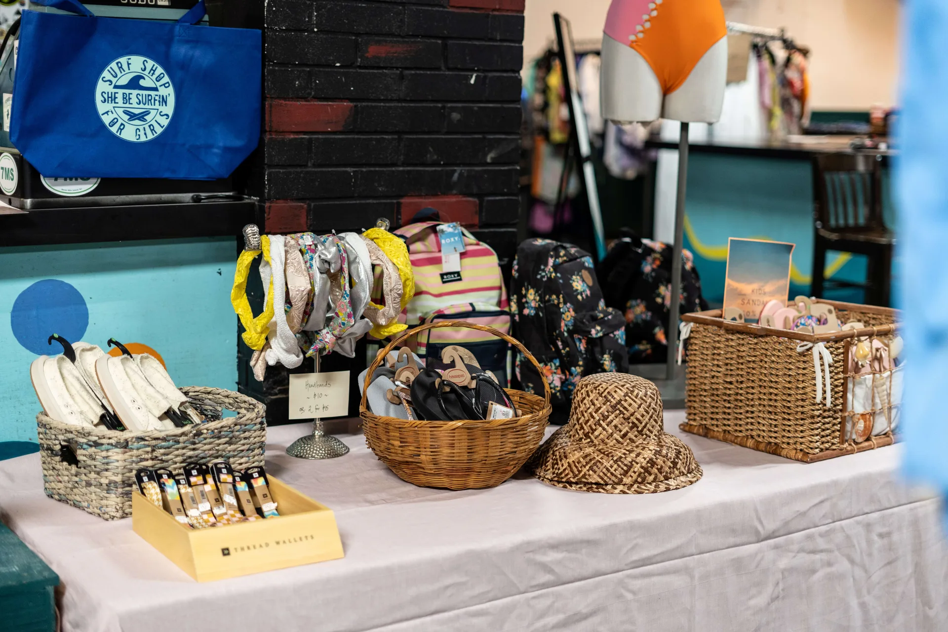 Accessories including hats, headbands, shoes, and watch bands on a table.