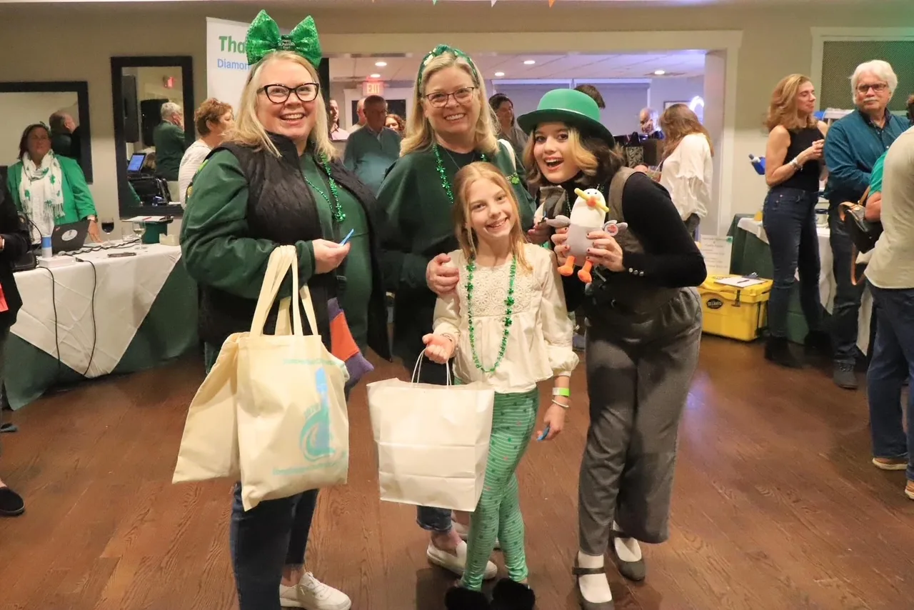 A family dressed in Irish-themed clothing.