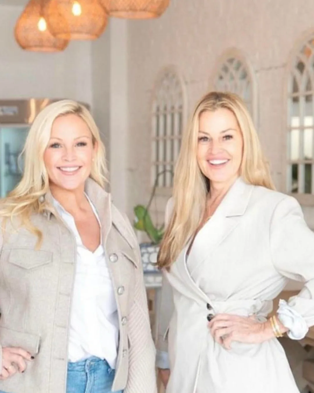 Two women standing next to each other at a restaurant. 